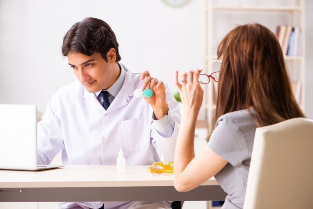 A young woman trialing a set of soft toric contact lenses during her contact lens fitting.