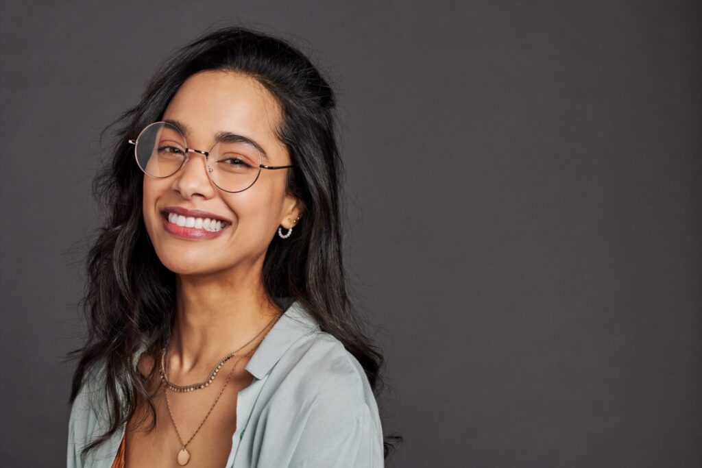 Young happy woman wearing round frames
